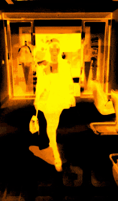 a blurred image of a person walking in front of a sign that says ' a ' on it