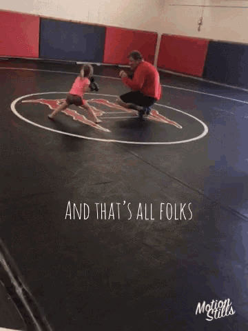 a man kneeling down with a little girl in a wrestling ring with the words " and that 's all folks "