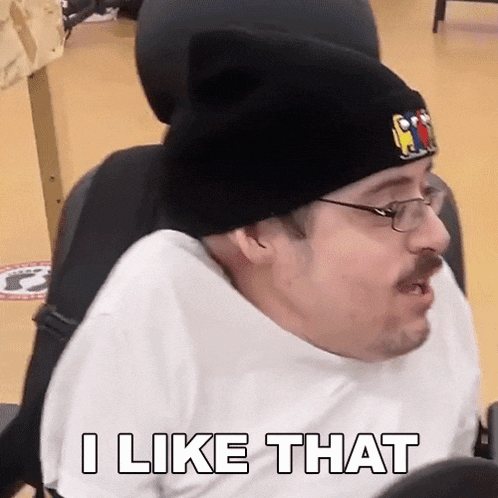 a man in a wheelchair wearing a beanie and glasses is saying i like that