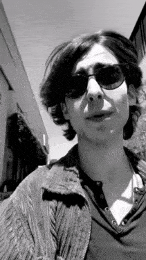 a black and white photo of a man wearing sunglasses