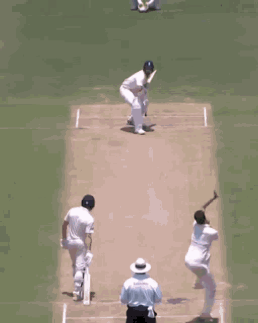 a man in a white shirt is catching a ball in front of a sign that says magi