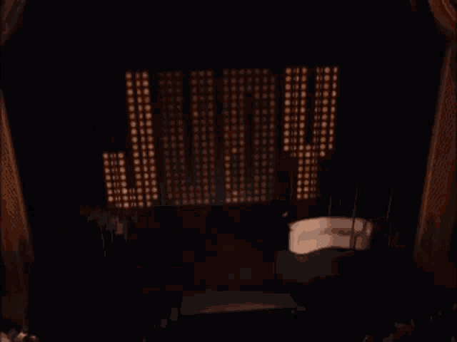 the word judy is displayed on a stage in a dark room