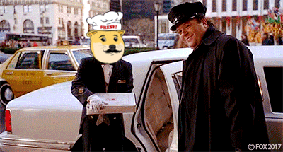 a man in a chef 's hat is holding a pizza box