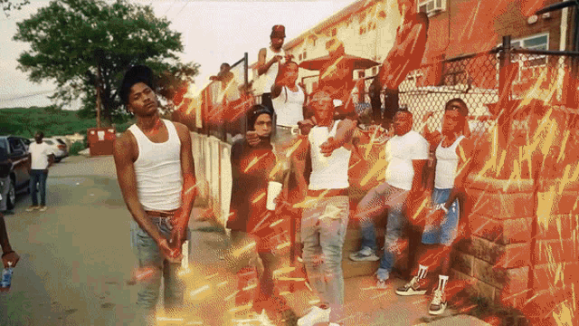 a group of men are standing in front of a building with graffiti on it that says ' a '