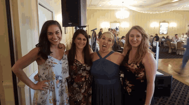 a group of women posing for a picture in a room with a speaker that says korg on it