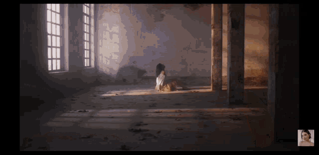 a woman is sitting on the floor in a room with columns