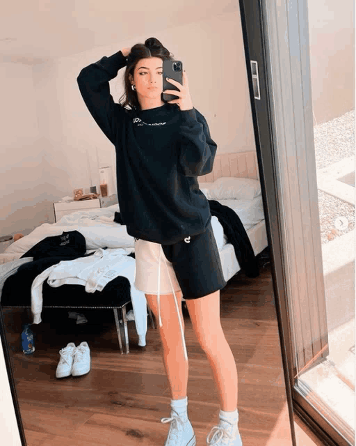 a girl is taking a picture of herself in a mirror