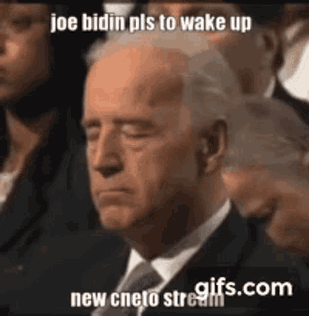 a man in a suit and tie with his eyes closed