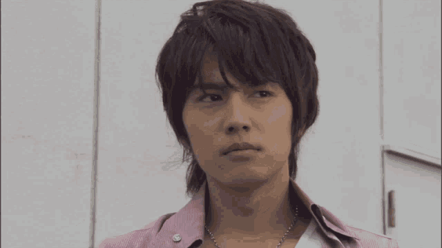 a close up of a man 's face with tv asahi in the upper right corner