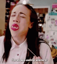 a woman is eating wieners and says i 'm stress eating wieners