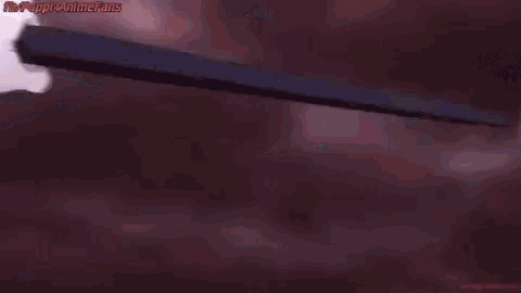 a person is holding a sword in their hand while another person holds a sword in their hand .