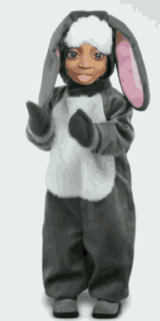 a child is dressed in a bunny costume and has a mask on their face