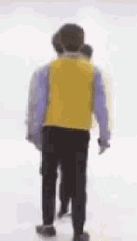 a blurry picture of two people walking on a white surface .