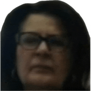 a close up of a woman 's face with glasses .