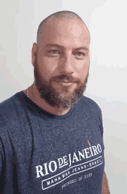 a man with a beard wears a blue shirt that says rio de janeiro
