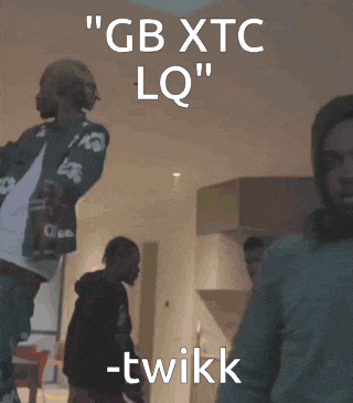 a group of people are standing in a room with the words " gb xtc lq " written on the top