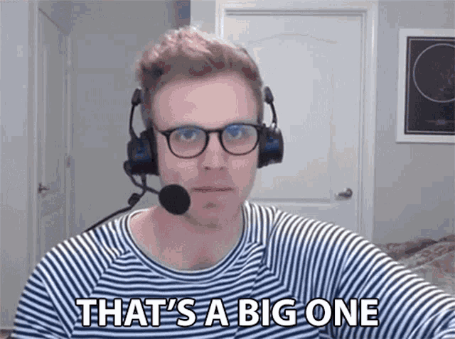 a man wearing headphones and glasses is saying that 's a big one