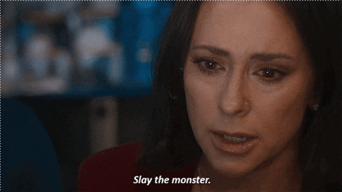 a close up of a woman 's face with the words " slay the monster " next to her