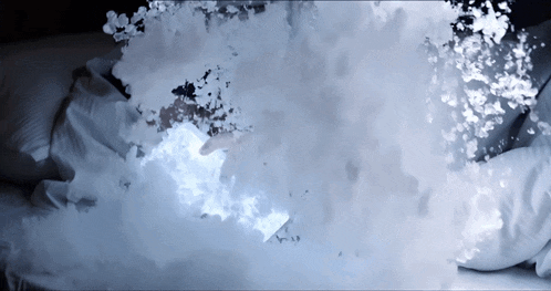 a person is laying on a bed with a lot of foam coming out of their head