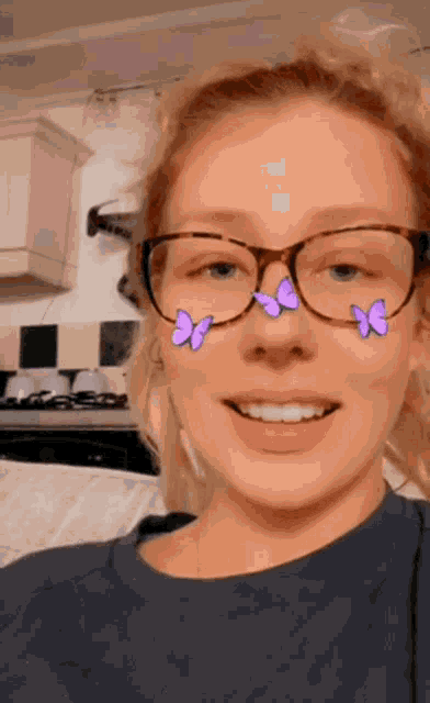 a woman wearing glasses with purple butterflies on her nose