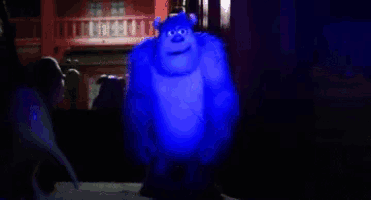 a blue light is shining on a person 's face in a dark room