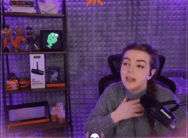 a woman is dancing in front of a shure microphone in a room with purple lights .