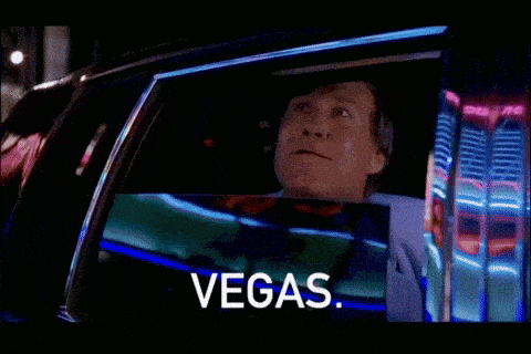 a man is sitting in a car with the word vegas on the screen