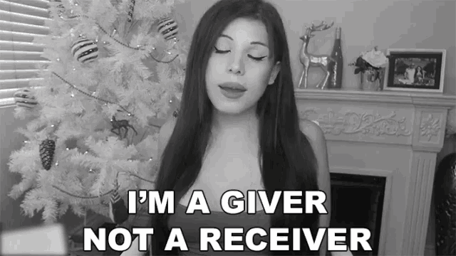 a woman singing in front of a white christmas tree with the words " i 'm a giver not a receiver "