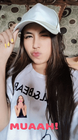 a woman wearing a white shirt with muaah written on it