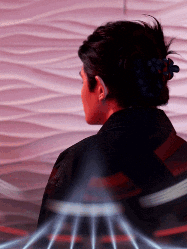 a woman 's back is shown with a purple background