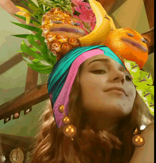 a woman wearing a turban with a pineapple banana and orange on her head