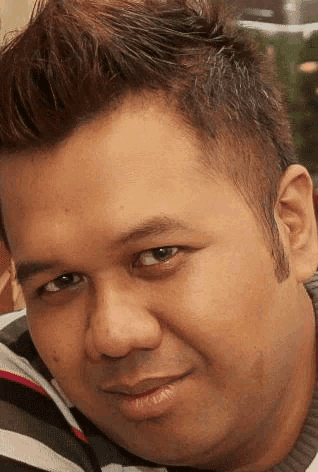 a close up of a man 's face with a striped sweater