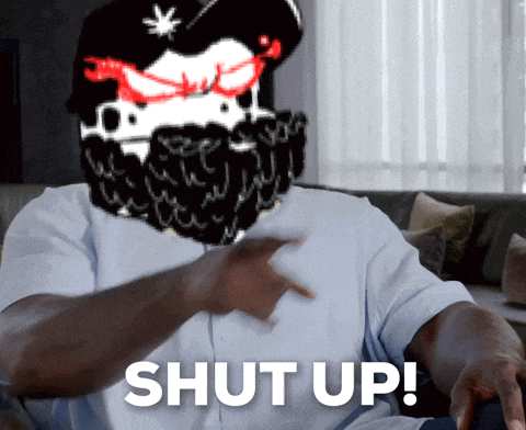 a man sitting on a couch with the word shut up behind him