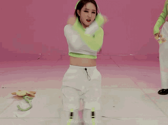 a woman in a neon green and white outfit is kneeling down