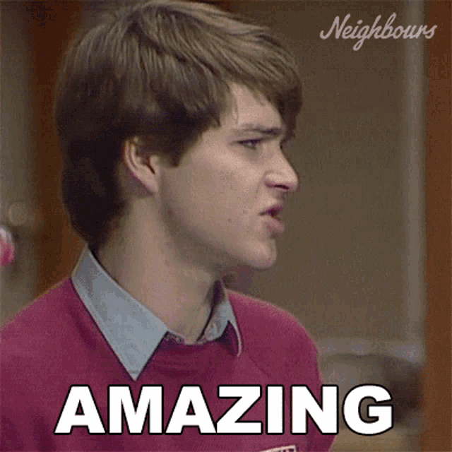 a man in a red sweater with the word amazing on it