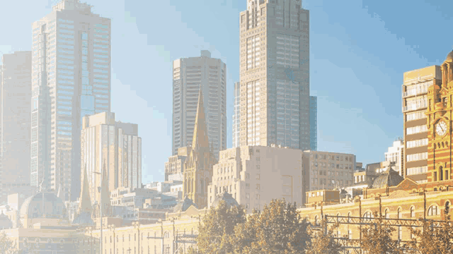 a statue of justice holding scales in front of a city skyline