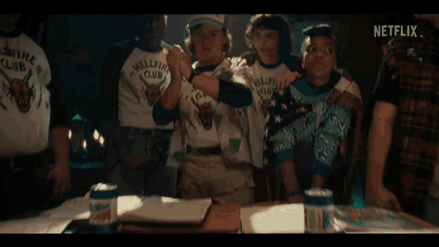 a group of boys wearing shirts that say hellfire club are standing next to each other