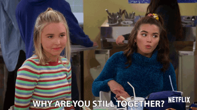 two girls are sitting at a table and one of them is asking the other why are you still together