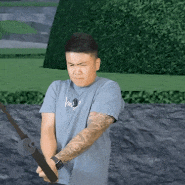 a man with a tattoo on his arm is holding a fishing rod