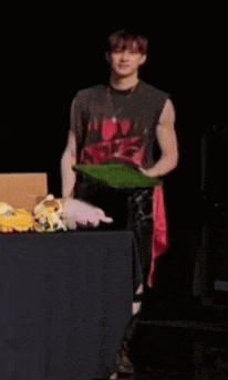 a man is standing in front of a table with stuffed animals on it ..