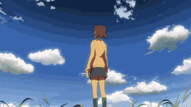 a girl in a yellow jacket stands in front of a blue sky