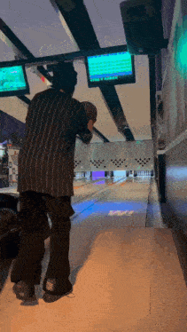 a bowling alley with a scoreboard that says ' strike '