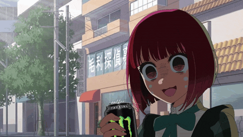 a girl is holding a monster energy drink