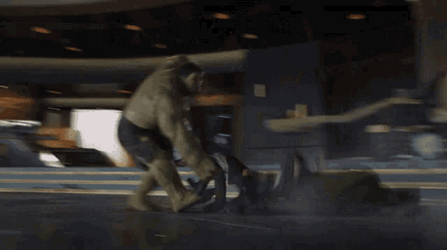 a hulk is standing on a person 's feet in a dark room