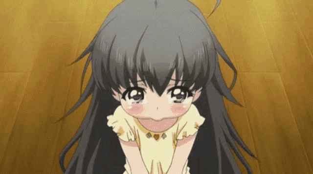a little girl in a yellow dress is kneeling down and crying