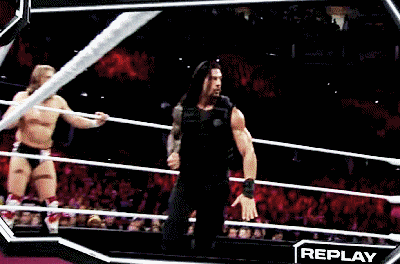 roman reigns is kicking john cena in the ring