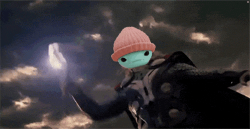 a frog wearing a pink beanie is holding a glowing object