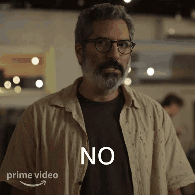 a man wearing glasses and a shirt that says " no "