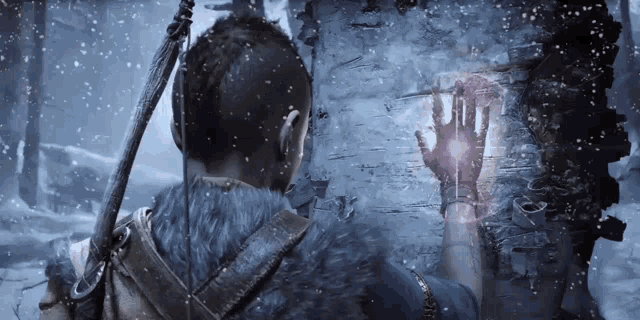 a man with a sword is standing in the snow with a glowing object in his hand