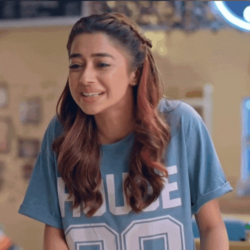 a woman wearing a blue t-shirt with the word house on it